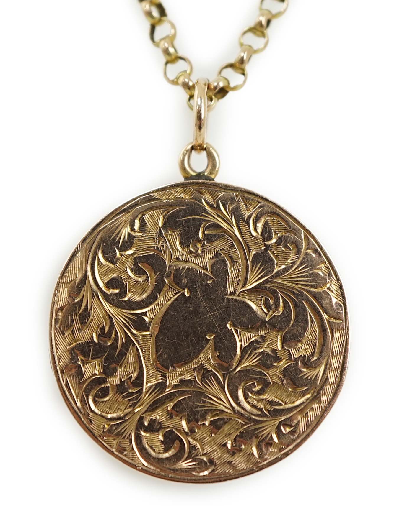 A George V engraved 9ct gold circular locket, diameter 25mm, on a 9ct chain, 45cm